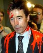Anders Fogh Rasmussen March 2003 with red paint, symbolizing blood, thrown by an activist in the Danish parliament as he was to announce Danish participation in the illegal war of aggression against Iraq